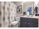 Bathroom vanity with patterned shower curtain and decorative picture at 6426 Queens Court Trce # 7, Mableton, GA 30126