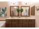 Double sink bathroom vanity with matching mirrors, decor, and decorative lighting at 6426 Queens Court Trce # 7, Mableton, GA 30126