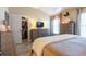 Bright bedroom featuring wood look floors, a large dresser, and a walk-in closet at 6426 Queens Court Trce # 7, Mableton, GA 30126