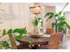 Cozy dining space under ornate chandelier, decorated with live plants and woven chairs at 6426 Queens Court Trce # 7, Mableton, GA 30126