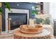 Close up of fireplace with white tile surround, black mantle, and decorative accents on wooden coffee table at 6426 Queens Court Trce # 7, Mableton, GA 30126