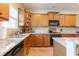 Well-lit kitchen with wooden cabinets, granite countertops, and modern stainless-steel appliances at 6426 Queens Court Trce # 7, Mableton, GA 30126