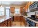 Modern kitchen features granite countertops, light wood cabinets, and modern appliances at 6426 Queens Court Trce # 7, Mableton, GA 30126