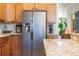 Bright kitchen boasts granite countertops, stainless steel refrigerator, and ample cabinet space at 6426 Queens Court Trce # 7, Mableton, GA 30126