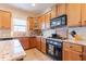Functional kitchen with light wood cabinets, granite countertops, and modern appliances at 6426 Queens Court Trce # 7, Mableton, GA 30126