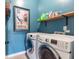 Well-lit laundry room with a washer and dryer set and practical shelf at 6426 Queens Court Trce # 7, Mableton, GA 30126