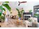 Open-concept living room with fireplace, dining area, wood floors, and large plants perfect for modern living at 6426 Queens Court Trce # 7, Mableton, GA 30126