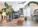 Cozy living room with fireplace, built-in shelving, wood floors and large plants, creating a warm atmosphere at 6426 Queens Court Trce # 7, Mableton, GA 30126