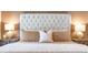 Close up of the main bedroom featuring a bed with a white tufted headboard at 6426 Queens Court Trce # 7, Mableton, GA 30126