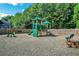 Community playground with a climbing structure, slide, and picnic table for Gathering fun at 6426 Queens Court Trce # 7, Mableton, GA 30126