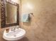 Charming powder room features decorative framed mirror, towel bar and pedestal sink at 6426 Queens Court Trce # 7, Mableton, GA 30126
