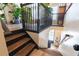 View of wood and black staircase landing with black railing, light wood floors, and bright white paint at 6426 Queens Court Trce # 7, Mableton, GA 30126