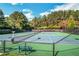 Outdoor tennis courts in a landscaped setting with green benches and available lighting for evening play at 6426 Queens Court Trce # 7, Mableton, GA 30126