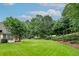Large, green backyard with mature trees, providing ample space for outdoor activities and recreation at 1000 Collingtree Ct, Mcdonough, GA 30253