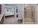 This bathroom features a tiled floor, a glass shower and a glimpse into the main bedroom at 1000 Collingtree Ct, Mcdonough, GA 30253