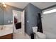 Ensuite bathroom with a toilet, a shower with a black curtain, and a sink with wood cabinets at 1000 Collingtree Ct, Mcdonough, GA 30253