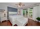 Well-lit bedroom features a king bed, wood floors, and access to the patio at 1000 Collingtree Ct, Mcdonough, GA 30253
