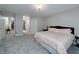 Spacious bedroom featuring neutral walls, plush carpeting and a comfortable bed with stylish patterned bedding at 1000 Collingtree Ct, Mcdonough, GA 30253