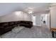 Large bonus room features neutral walls, carpeted floors, and a dark leather couch at 1000 Collingtree Ct, Mcdonough, GA 30253