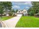 Charming two-story home with manicured lawn, stone accents, a driveway and an attached two-car garage at 1000 Collingtree Ct, Mcdonough, GA 30253