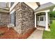 Close-up of home's stone exterior, window shutters, and well-maintained front entrance at 1000 Collingtree Ct, Mcdonough, GA 30253