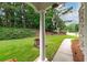 Lush front yard with healthy green grass and a paved walkway, framed by mature trees at 1000 Collingtree Ct, Mcdonough, GA 30253