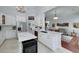 Modern kitchen features white cabinets, marble countertops, stainless steel appliances, and an island with a wine cooler at 1000 Collingtree Ct, Mcdonough, GA 30253