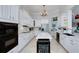 Bright kitchen boasts white cabinets, marble countertops, an island with a wine cooler, and stainless steel appliances at 1000 Collingtree Ct, Mcdonough, GA 30253