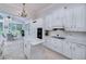 Well-lit kitchen features white cabinets, an island with a marble countertop, and stainless steel appliances next to breakfast nook at 1000 Collingtree Ct, Mcdonough, GA 30253