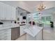 Bright, spacious kitchen features white cabinets, marble countertops, and stainless steel appliances next to vaulted breakfast nook at 1000 Collingtree Ct, Mcdonough, GA 30253