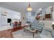Open concept living area with a view of the kitchen and dining area, with hardwood flooring at 1000 Collingtree Ct, Mcdonough, GA 30253