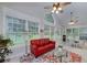 Bright living room has large windows overlooking the yard, vaulted ceilings, and a red couch at 1000 Collingtree Ct, Mcdonough, GA 30253