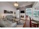 Open concept living area with fireplace, backyard access, and a view of the kitchen at 1000 Collingtree Ct, Mcdonough, GA 30253