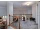 Cozy loft area with gray carpet, stylish decor, and a view of the living room below at 1000 Collingtree Ct, Mcdonough, GA 30253