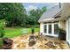 Inviting flagstone patio with outdoor seating overlooking a beautifully landscaped yard and mature trees at 1000 Collingtree Ct, Mcdonough, GA 30253