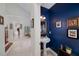 This powder room features blue walls, a pedestal sink, decorative lighting, and decorative wall art at 1000 Collingtree Ct, Mcdonough, GA 30253