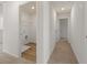 Hallway with laundry closet featuring wood flooring at 1236 Arnhem Dr, Hampton, GA 30228