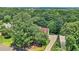 Aerial view of a home with a driveway surrounded by trees at 2020 Ridge Gate Drive Dr, Cumming, GA 30041