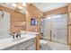 Bright bathroom with a vanity, toilet, and shower-tub combo with a glass door at 2020 Ridge Gate Drive Dr, Cumming, GA 30041