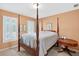 Traditional bedroom features a four-poster bed, neutral walls and bright, shuttered windows at 2020 Ridge Gate Drive Dr, Cumming, GA 30041