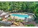 A view of the community pool and playground in a wooded setting at 2020 Ridge Gate Drive Dr, Cumming, GA 30041