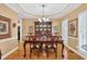 Elegant dining room with hardwood floors, a chandelier, and decorative shutters at 2020 Ridge Gate Drive Dr, Cumming, GA 30041