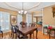 Warm dining room featuring hardwood floors, a chandelier, and ample natural light from windows at 2020 Ridge Gate Drive Dr, Cumming, GA 30041