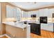 Modern kitchen featuring white cabinets, stainless steel appliances, and ample counter space at 2020 Ridge Gate Drive Dr, Cumming, GA 30041