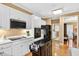 Modern kitchen with white cabinetry, black appliances, and a functional island at 2020 Ridge Gate Drive Dr, Cumming, GA 30041