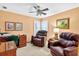 Cozy sitting room with plush chairs, ceiling fan, and shuttered windows offering natural light at 2020 Ridge Gate Drive Dr, Cumming, GA 30041
