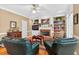 Warm living room with a brick fireplace, built-in bookshelves, and comfortable seating at 2020 Ridge Gate Drive Dr, Cumming, GA 30041