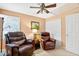 Inviting living room features comfortable seating, a ceiling fan, and bright shuttered windows at 2020 Ridge Gate Drive Dr, Cumming, GA 30041