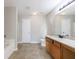 Bathroom features a bathtub, separate glass-enclosed shower, tile floors, and a wood vanity at 2873 Snapfinger Mnr, Decatur, GA 30035