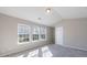 Bright bedroom with neutral walls and grey carpet features three windows and lots of natural light at 2873 Snapfinger Mnr, Decatur, GA 30035